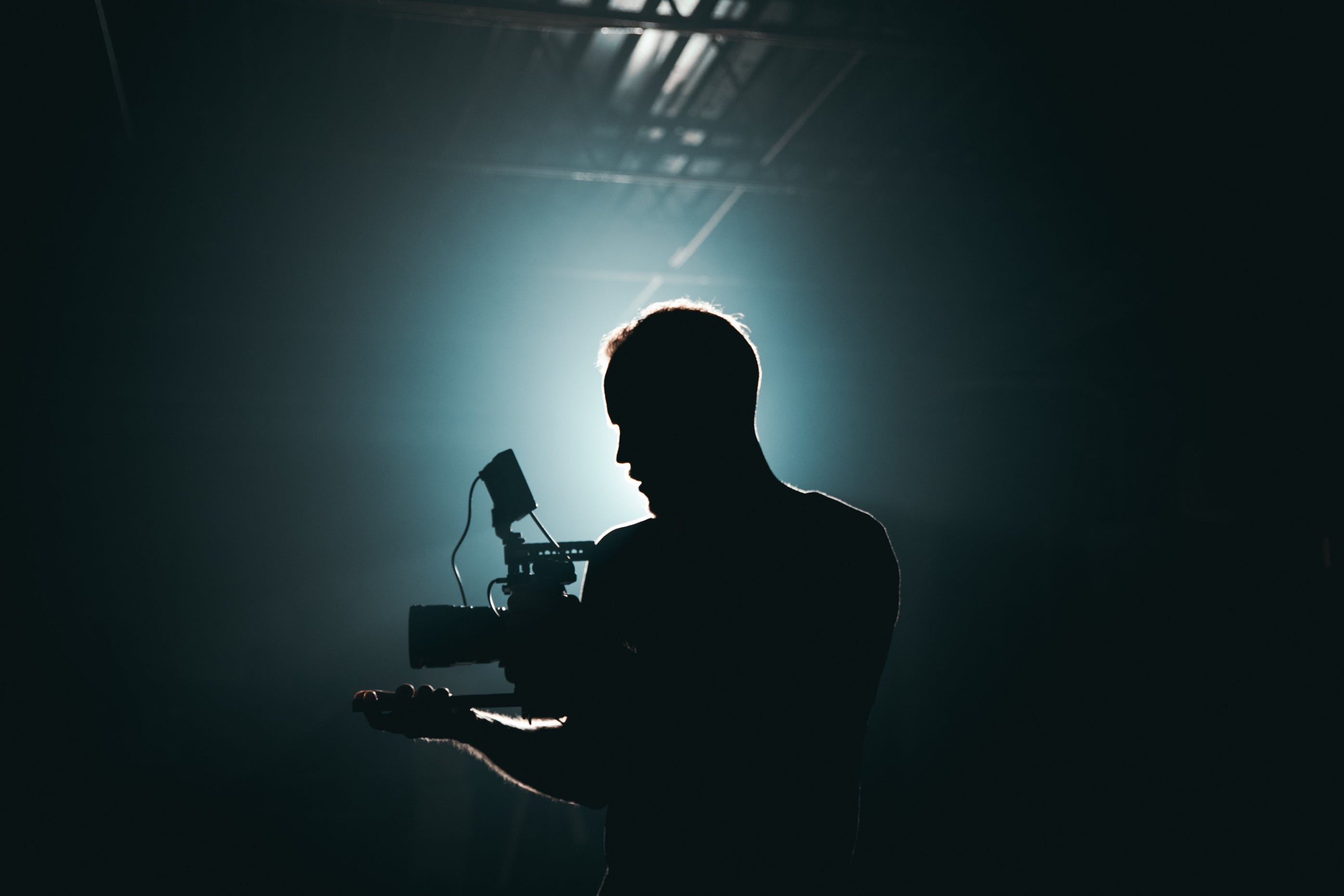 Person holding a video camera in dark